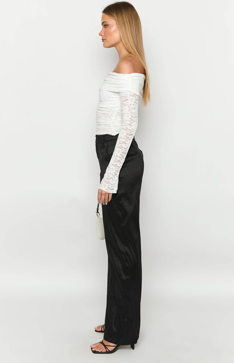 Side view of black satin wide-leg pants with a relaxed fit, showing the full length and subtle sheen