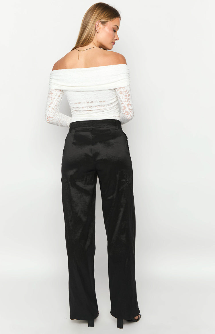 Rear view of black satin wide-leg pants with a smooth, flowing silhouette