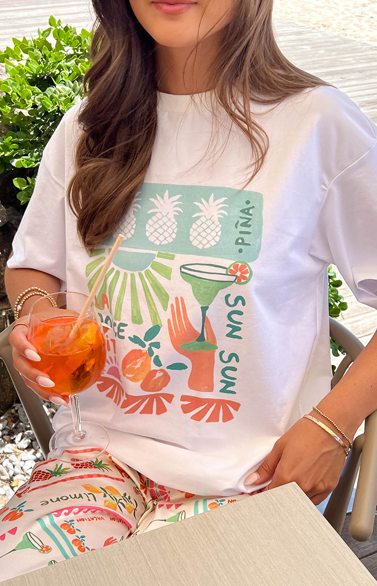 Beginning Boutique Jaz Dolce Vita Print Tee white oversized crew neck tee with a colourful graphic print of pineapples and cocktails