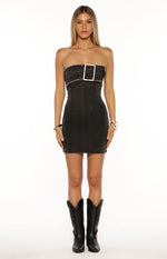 Front view of a black washed denim strapless mini dress with a large silver buckle and frayed trim at the bust