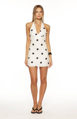 White polka dot mini dress with a deep V-neck halter neckline and a fitted bodycon silhouette