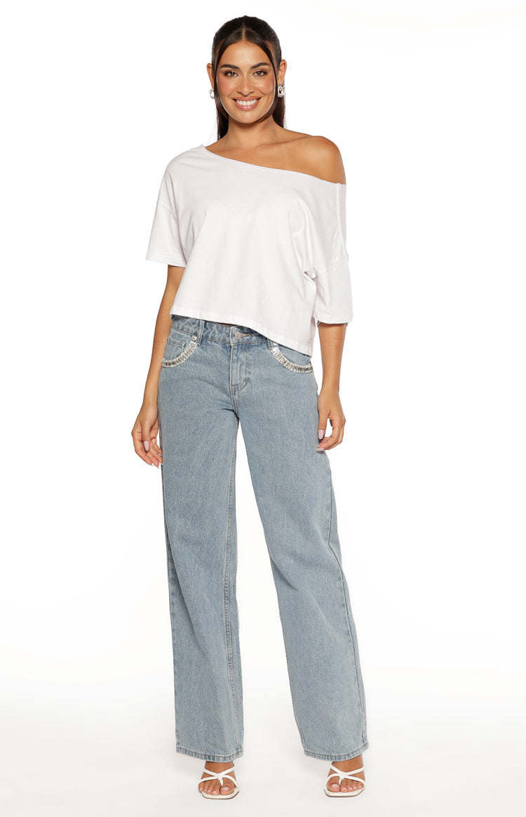 Light wash denim low rise wide leg jeans with diamante trim on the front pockets