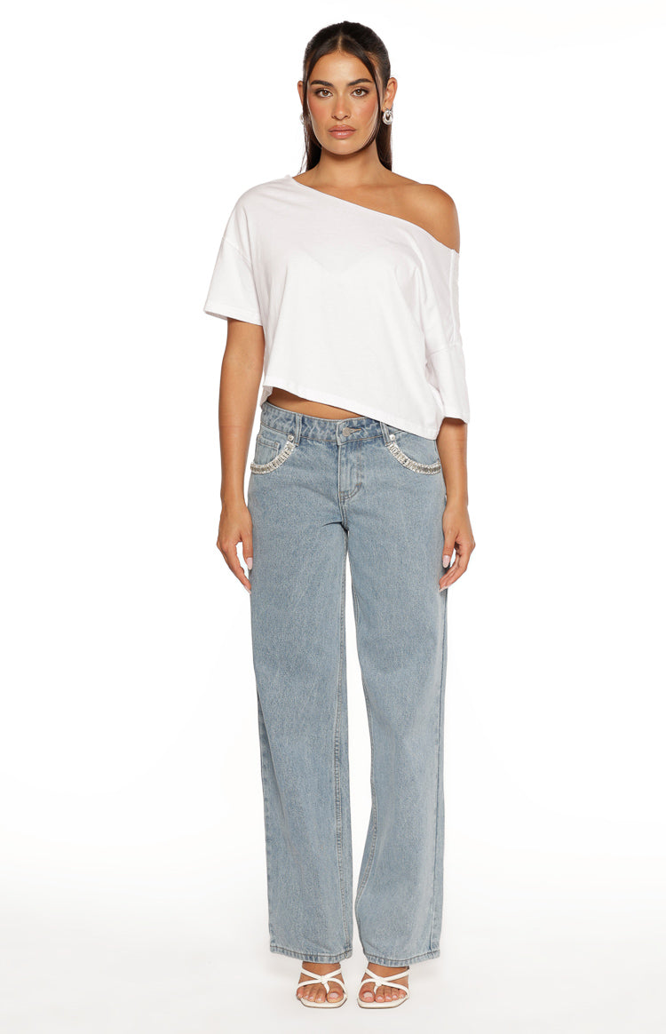 Front view of light wash denim low rise jeans with diamante trim along the pockets and a wide leg fit