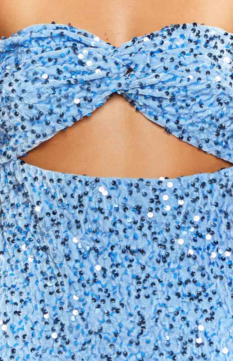 Close-up of the twisted strapless bust and midriff cutout on a blue sequin mini dress