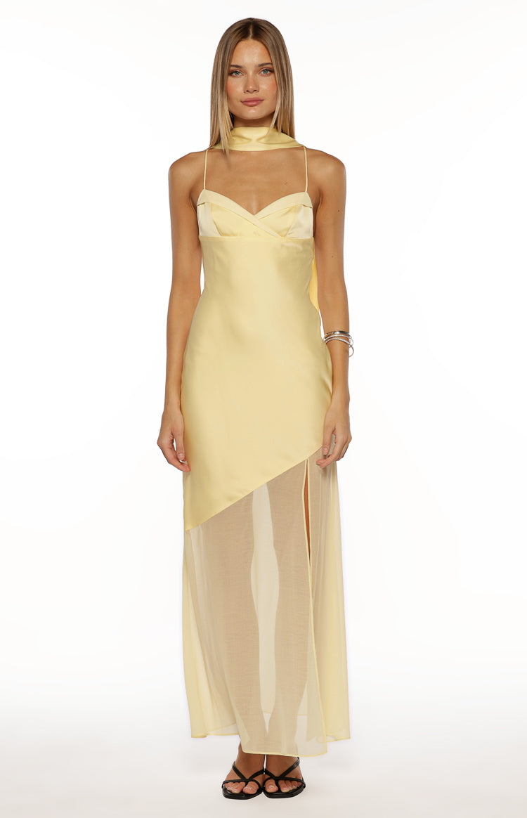 Front view of the yellow satin maxi dress with a diagonal sheer skirt panel and high side slit