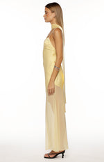 Side view of a yellow satin maxi dress with a long scarf neck detail, thin spaghetti straps, and a sheer chiffon overlay skirt
