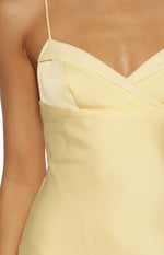 Close-up of the yellow satin sweetheart neckline with a wrapped bodice detail and thin spaghetti strap