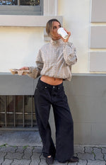 Front view of a beige plaid funnel neck jacket with a full zip, cropped elasticated hem, and long puff sleeves