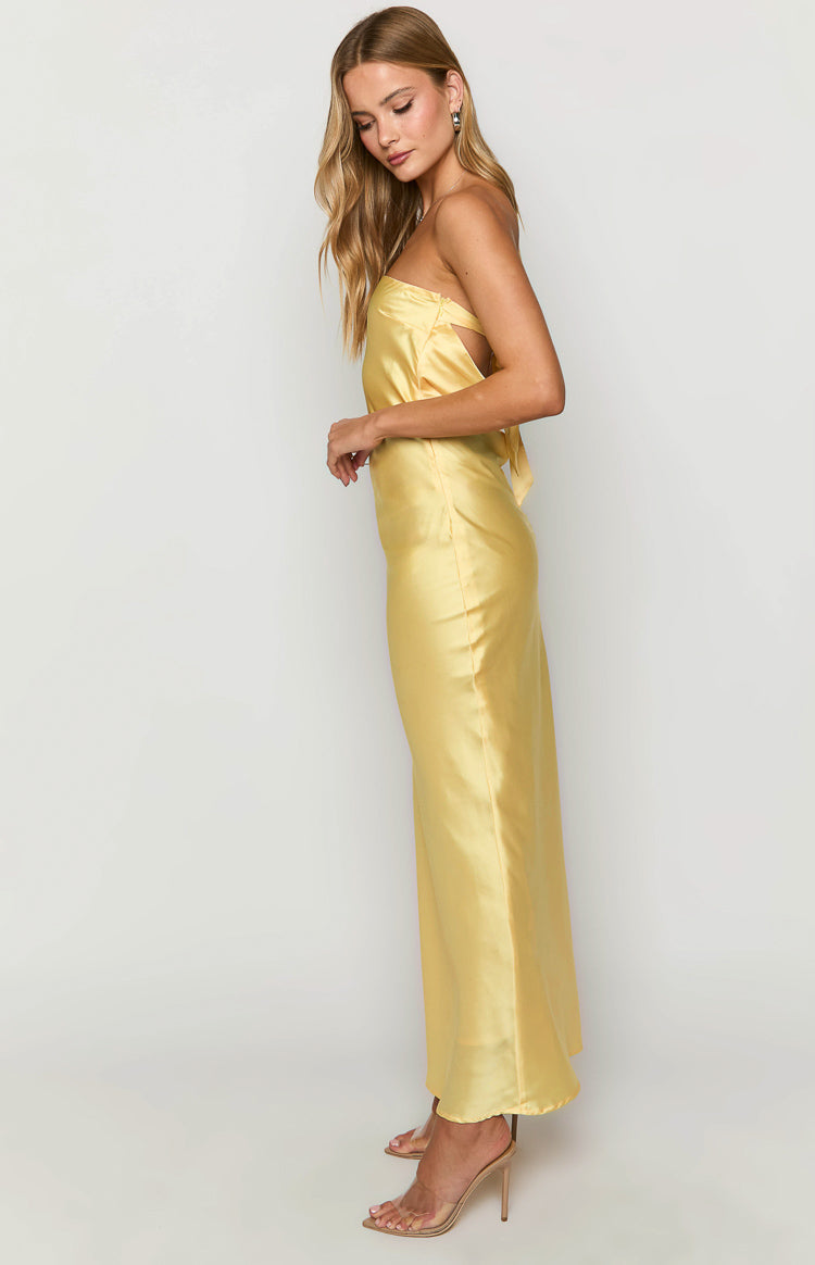 Side view of a yellow satin maxi dress with a strapless neckline and tie-back detail