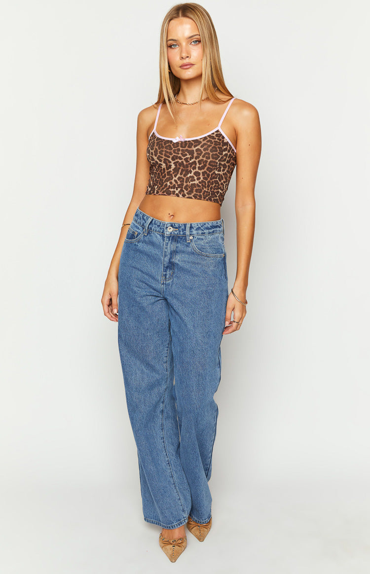 Front view of a brown leopard print cami crop top with pink trim and a small pink bow