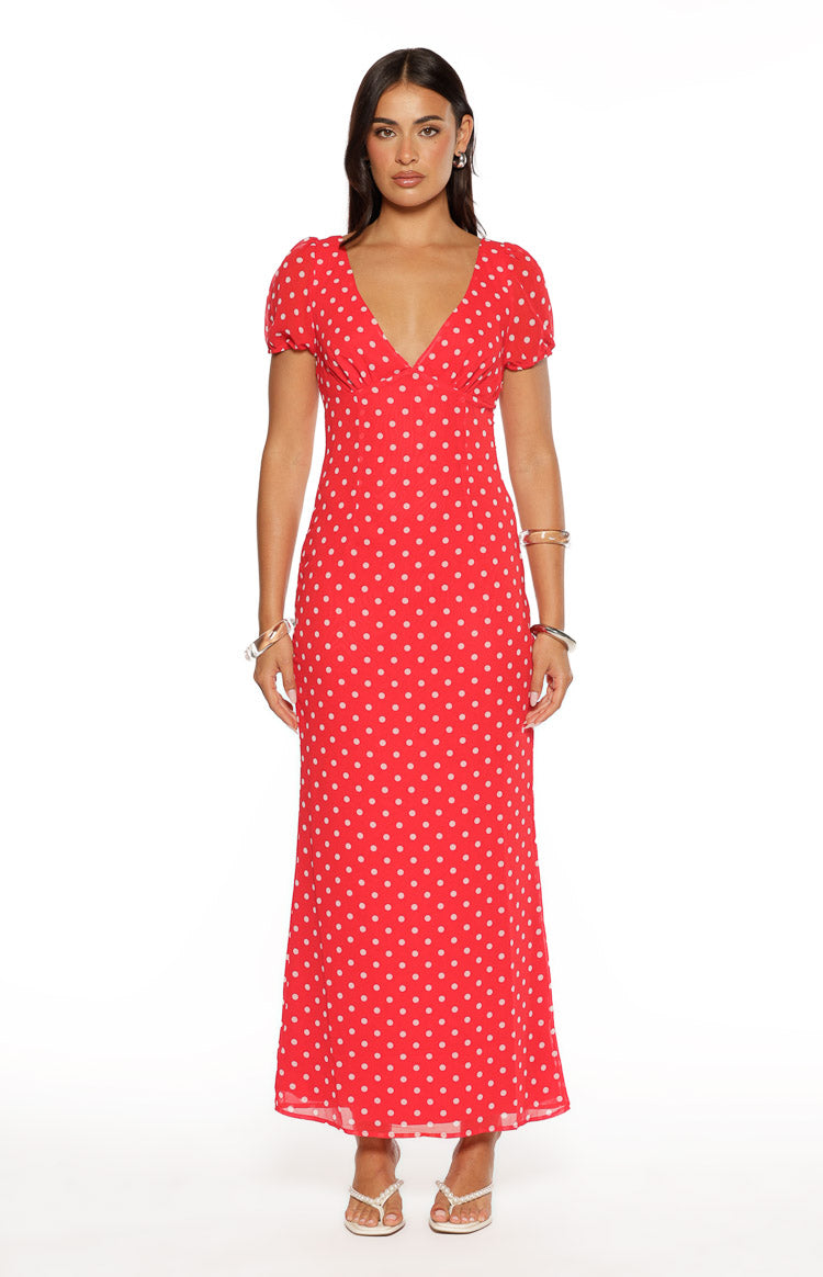 Front view of a red maxi dress with white polka dots, V-neckline, and short puff sleeves