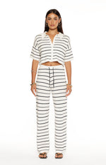 Full length view of white and navy stripe knit pants with a relaxed wide-leg fit and drawstring waist