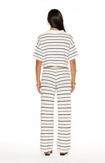 Rear view of white and navy stripe knit wide-leg pants with a V-shaped seam at the back waist