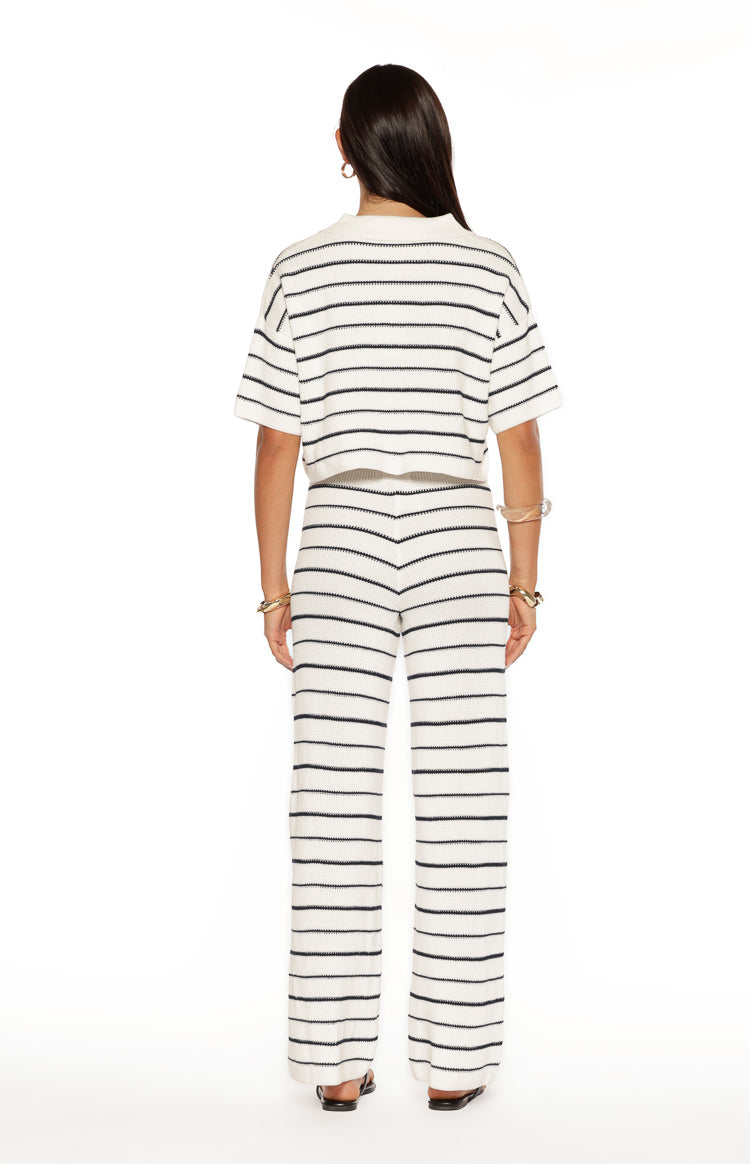 Rear view of white and navy stripe knit wide-leg pants with a V-shaped seam at the back waist