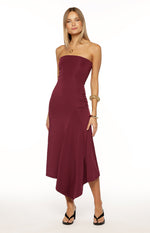 Plum strapless midi dress with a fitted bodice, ruched side detail, and a flowing asymmetrical handkerchief hem