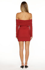 Rear view of a red off-the-shoulder mini dress with ruched neckline, long sleeves, and scalloped hem