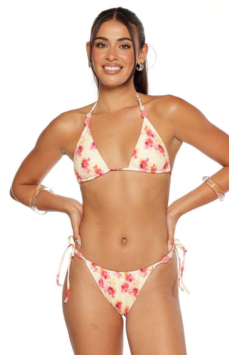 Yellow and pink floral print triangle bikini top featuring pink and cream beads on halter straps and matching tie-side bottoms