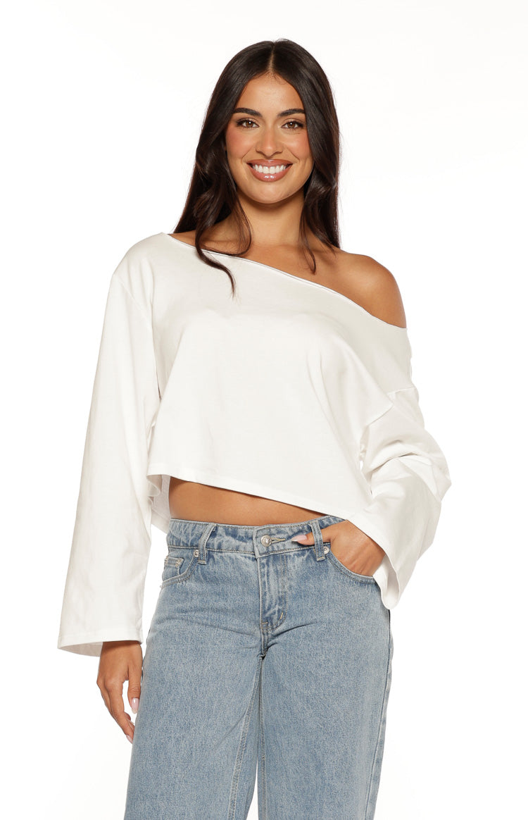 White relaxed fit off-shoulder long sleeve top with a wide neckline and cropped hem