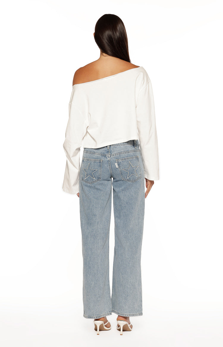 Rear view of a white off-shoulder long sleeve top with a raw edge neckline and cropped hem