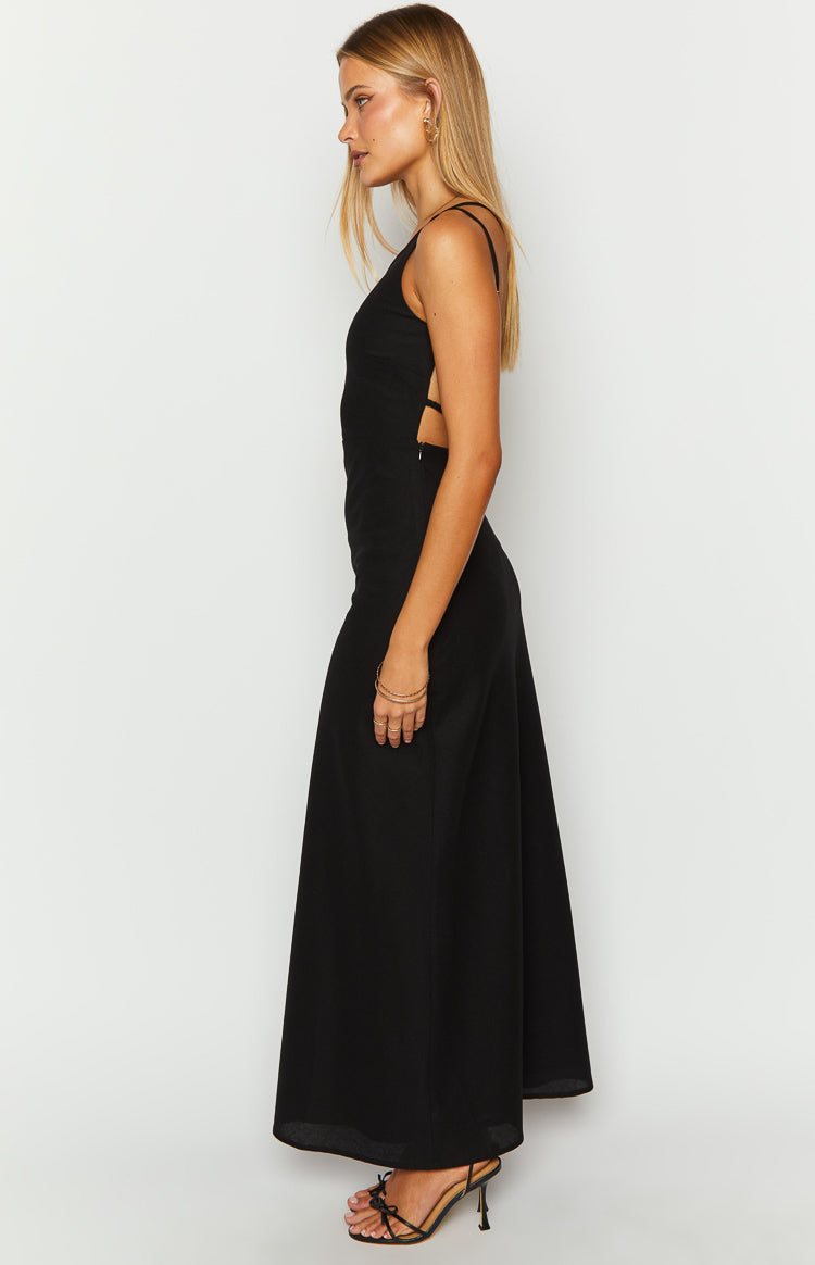 Side view of a black linen blend maxi dress showing the side cutouts and thin straps