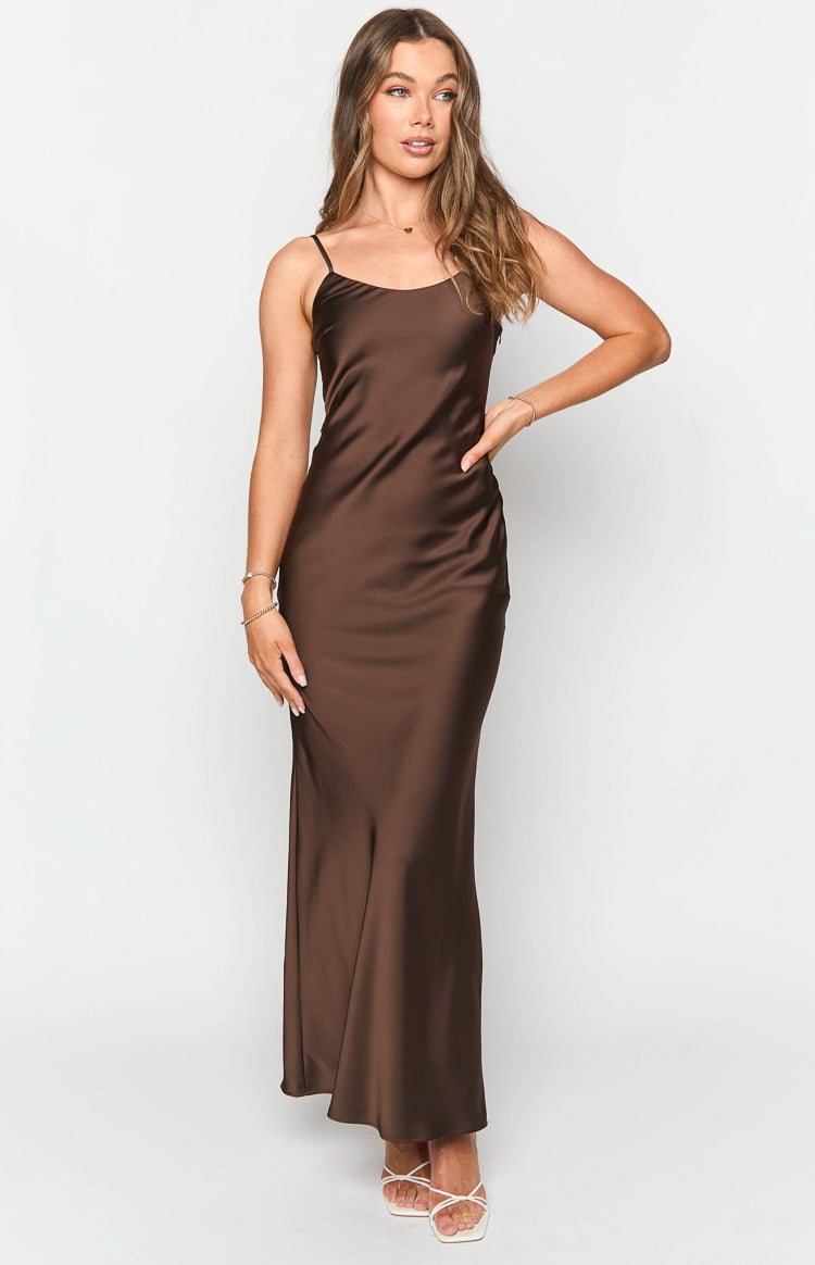 Brown satin maxi dress with a scoop neckline, delicate spaghetti straps, and a flowing skirt