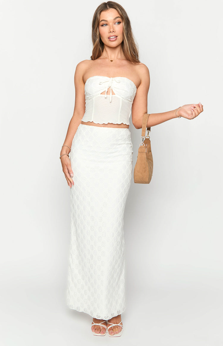 White maxi skirt with an intricate geometric lace pattern and a fitted silhouette
