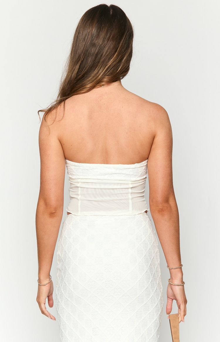Rear view of a white strapless crop top with sheer back panels and structured seams