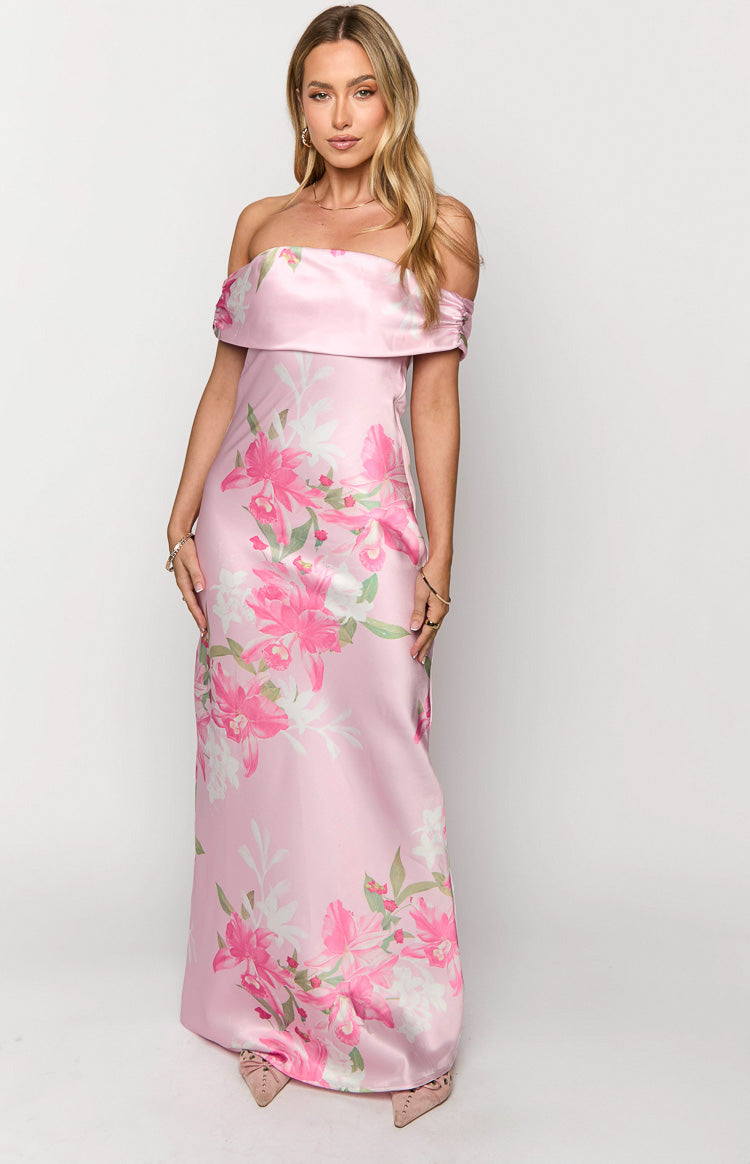Pink satin off-the-shoulder maxi dress with a wide folded neckline and vibrant pink and white floral print