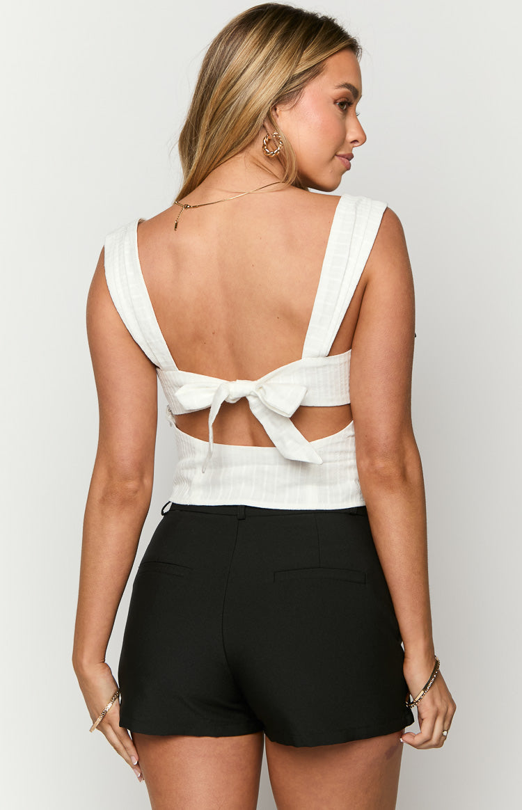 Rear view of the black mini skort showing a smooth, fitted silhouette with subtle back seams