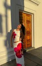 White maxi skirt with a large pink orchid print and a bodycon fit