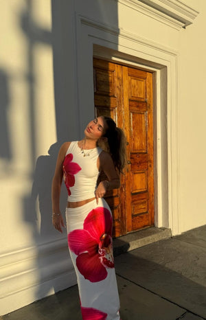 White maxi skirt with a large pink orchid print and a bodycon fit