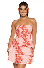 Pink floral strapless mini dress with tiered ruffles and white pom-pom trim