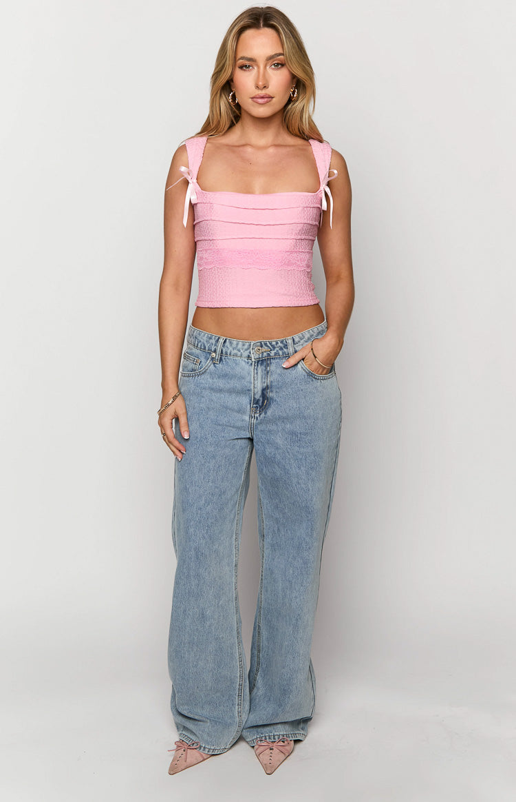 Front view of mid wash low rise wide leg jeans with a relaxed fit and full length