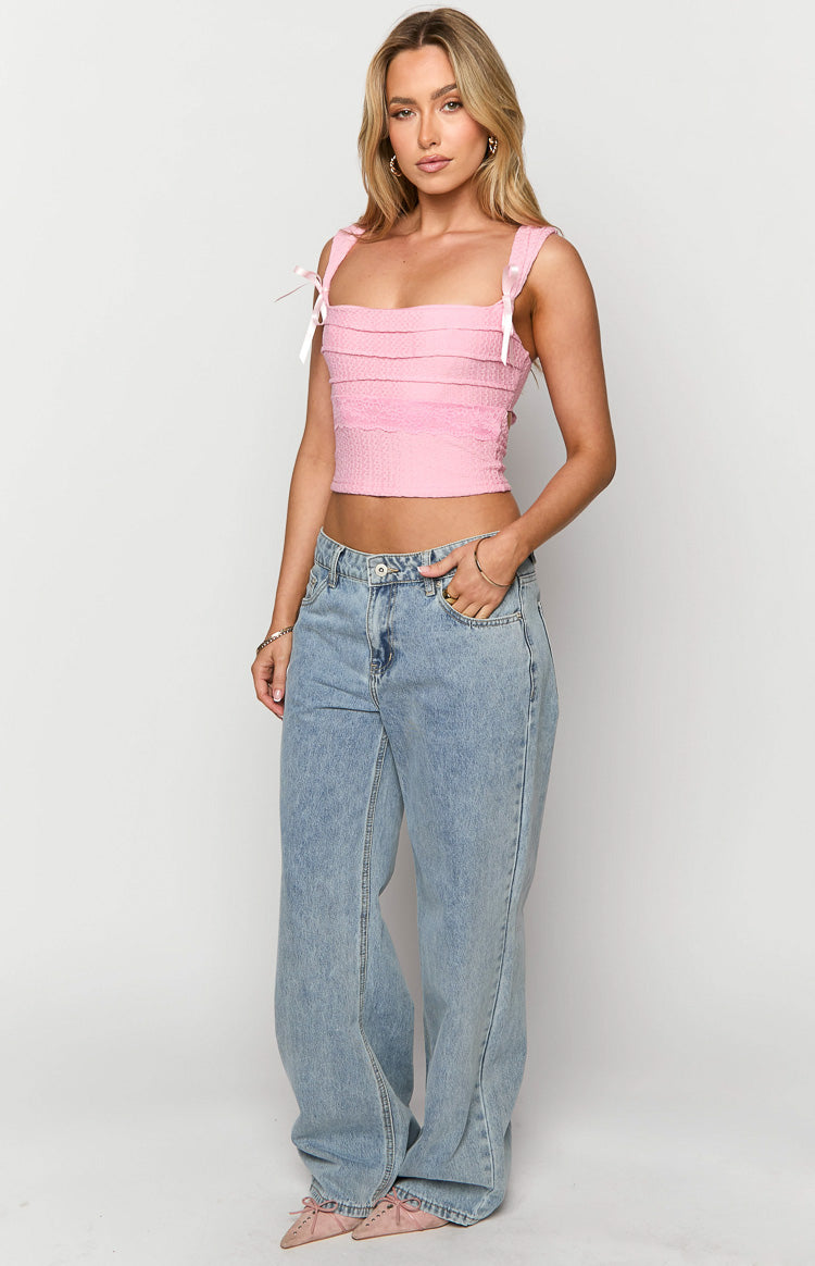 Mid wash blue low rise wide leg jeans with a relaxed, baggy fit and long hem