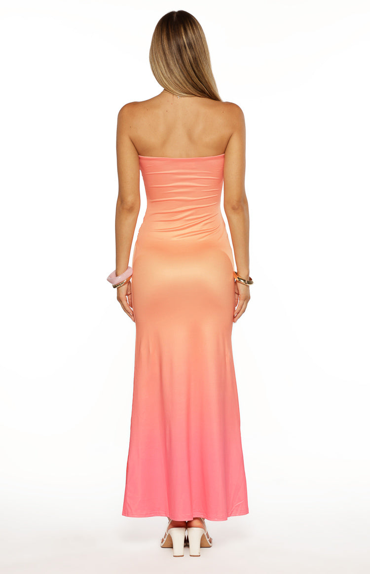 Back view of the strapless maxi dress, showing the smooth fabric and pink ombre effect from peach to coral