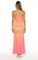 Back view of the strapless maxi dress, showing the smooth fabric and pink ombre effect from peach to coral