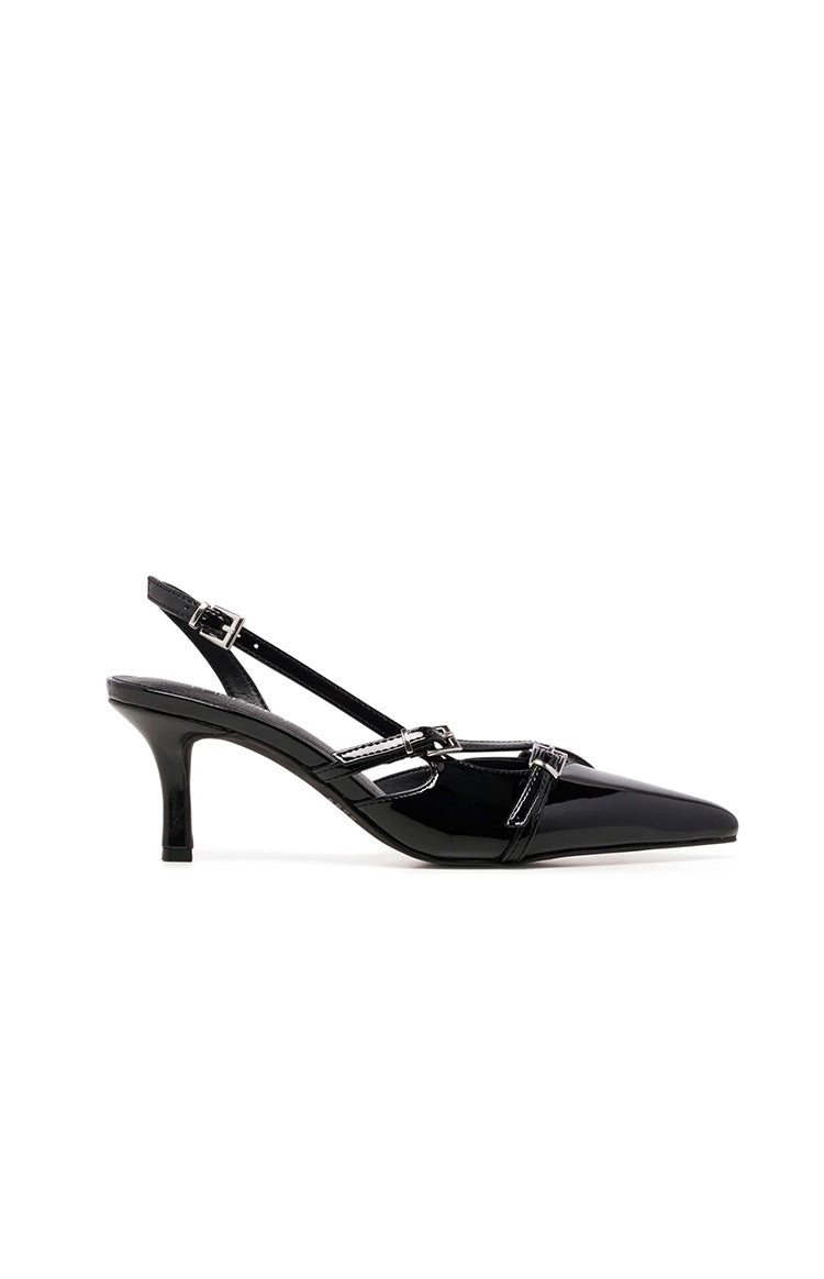 Side view of a black patent slingback heel with a pointed toe, kitten heel, and decorative buckled straps