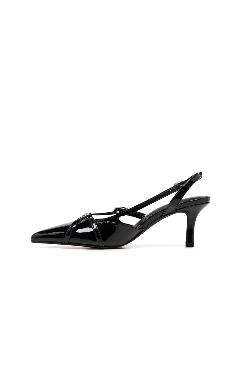 Side view of black patent slingback heels with pointed toe and criss-cross straps over the vamp