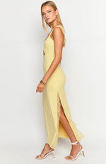 Side view of a yellow lace maxi dress showing the side cut-out and high leg slit with lace trim
