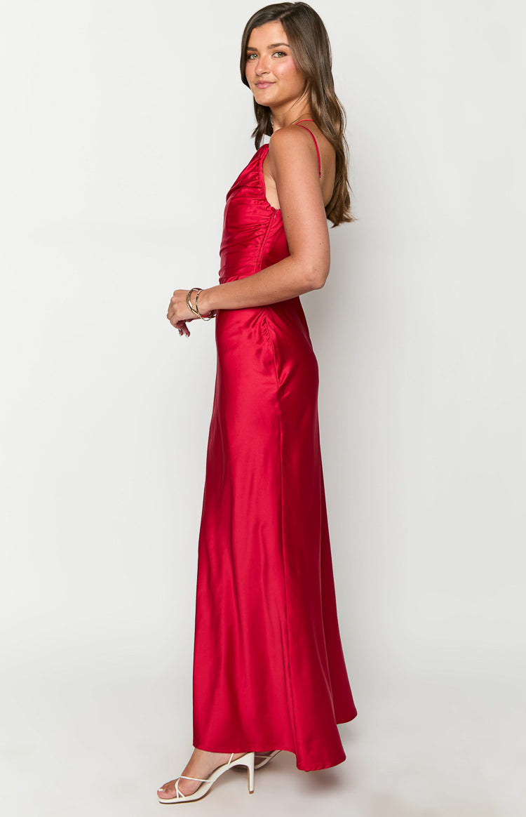 Side view of a red satin formal maxi dress showing the cowl neckline, thin spaghetti straps, and ruched bodice