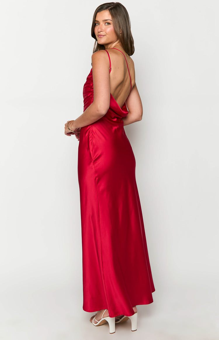 Side view of a red satin maxi dress featuring a low cowl back, thin spaghetti straps, and side ruching