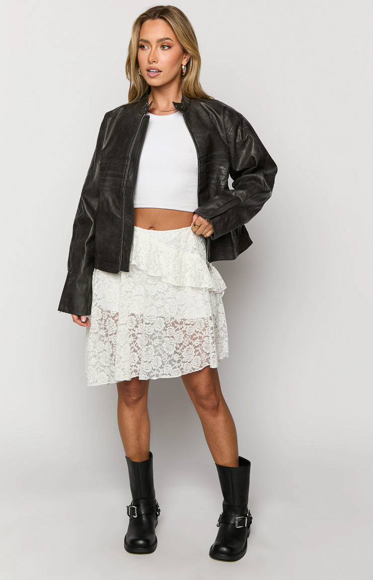 White lace mini skirt with tiered ruffles and a sheer floral lace pattern