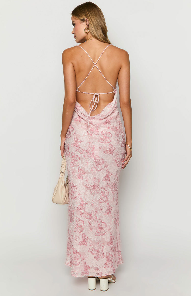 Back view of a pink butterfly print maxi dress with criss-cross back straps and a low cowl back with tie closure