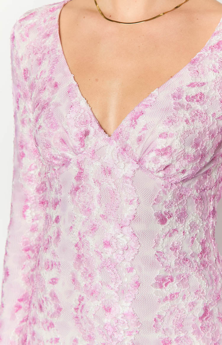 Close-up of the V-neckline and ruched bust detail on a pink and white floral lace long sleeve maxi dress
