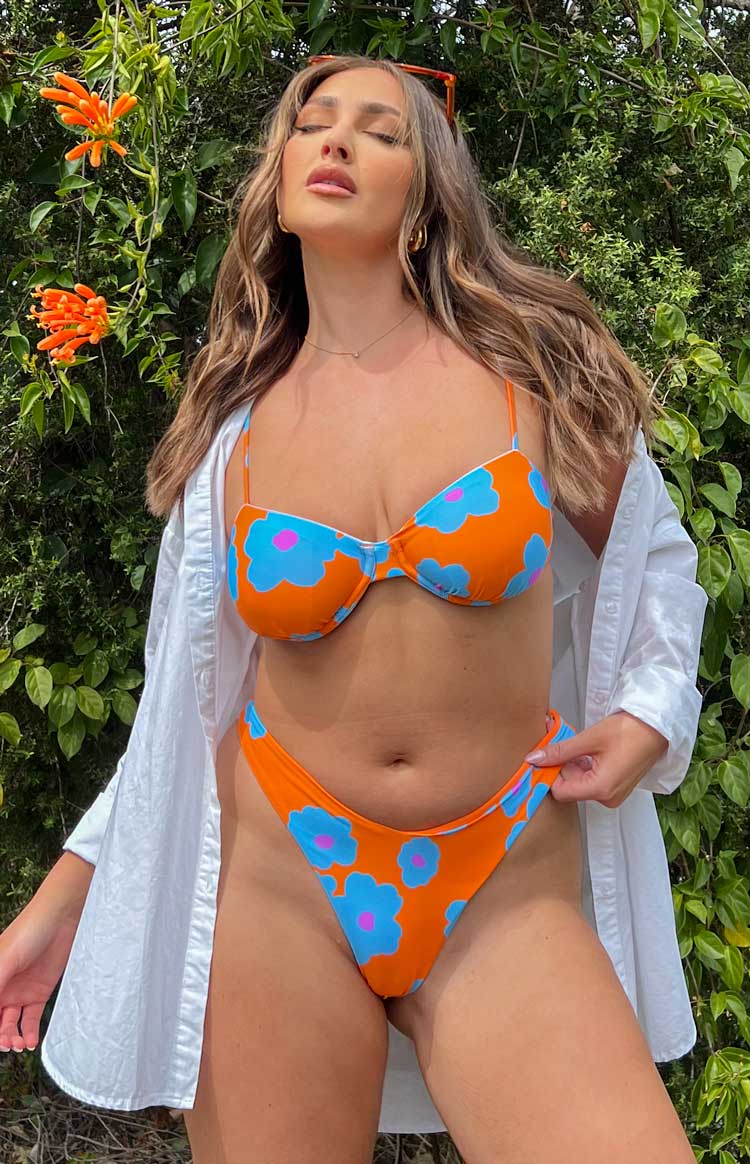 Orange floral bikini bottoms with a high-cut V-front and blue and pink flower pattern