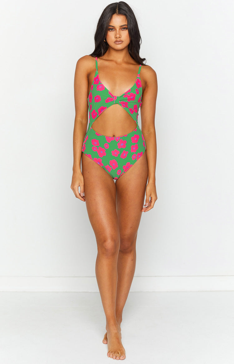 Front view of a green one piece swimsuit with pink floral print, featuring a twisted V-neck and midriff cut out
