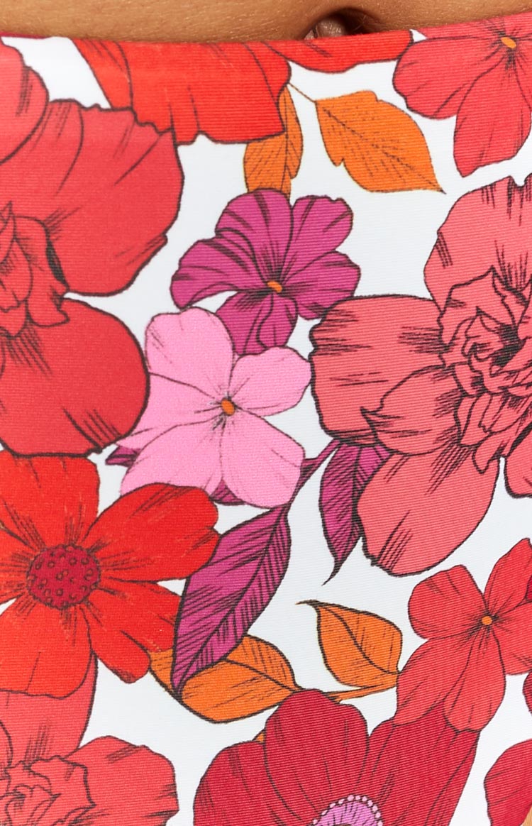 Close-up of the pink, red, and fuchsia floral print with orange and magenta leaves on the bikini bottoms