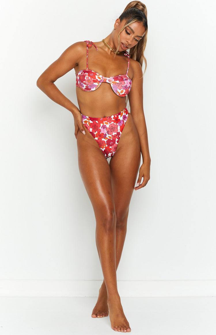 Front view of high-waisted pink floral bikini bottoms with a high-cut leg and vibrant red and pink flowers