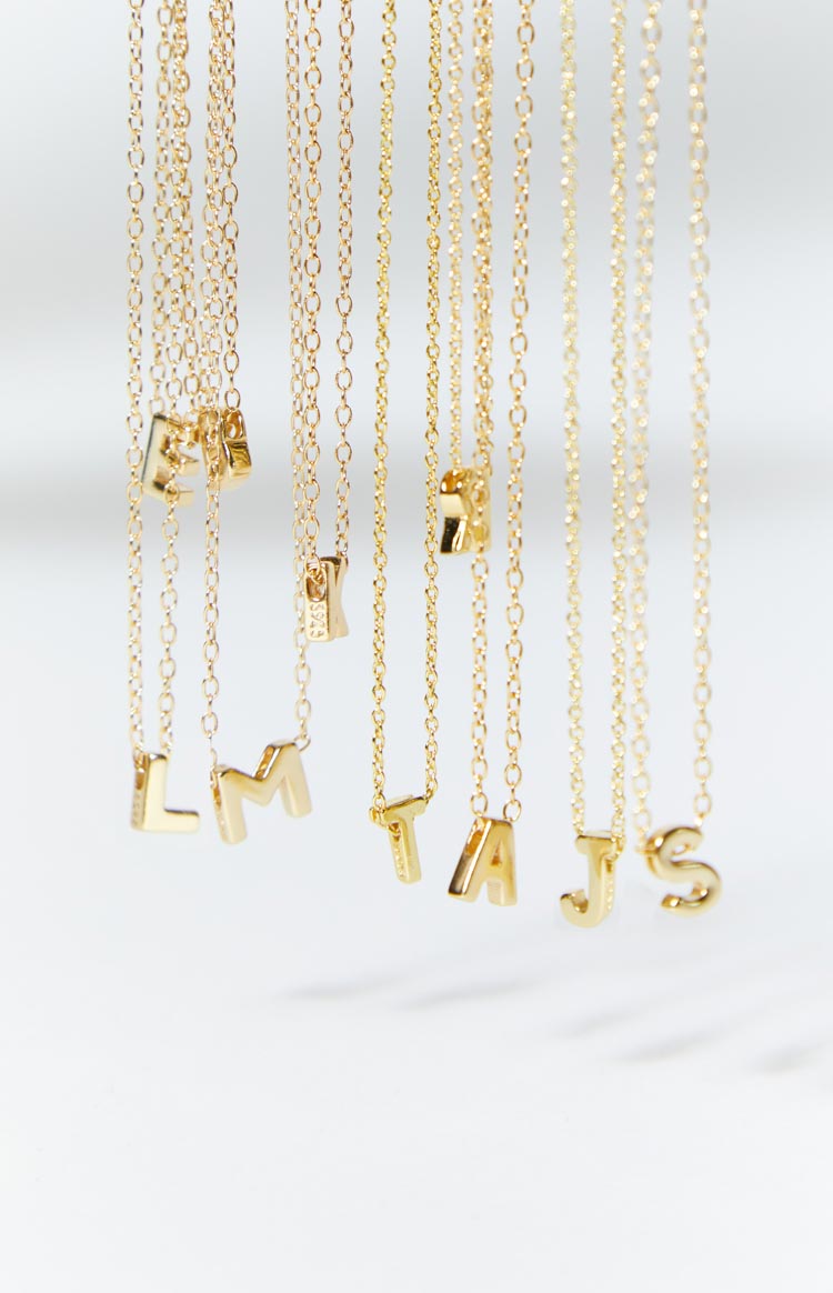 Beginning Boutique 18k Letter Gold Necklace multiple 18k gold necklaces with delicate chains and individual letter pendants