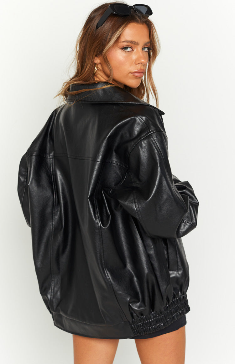 Rear view of an oversized black PU bomber jacket with a relaxed fit and elasticated hem